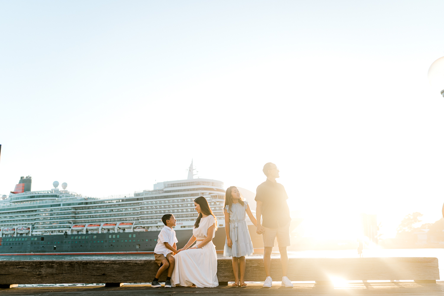 Family of four enjoying sunrise at the Sydney Harbour