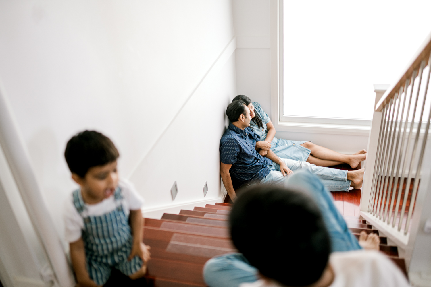 Mum and dad having own space with kids playing around at home