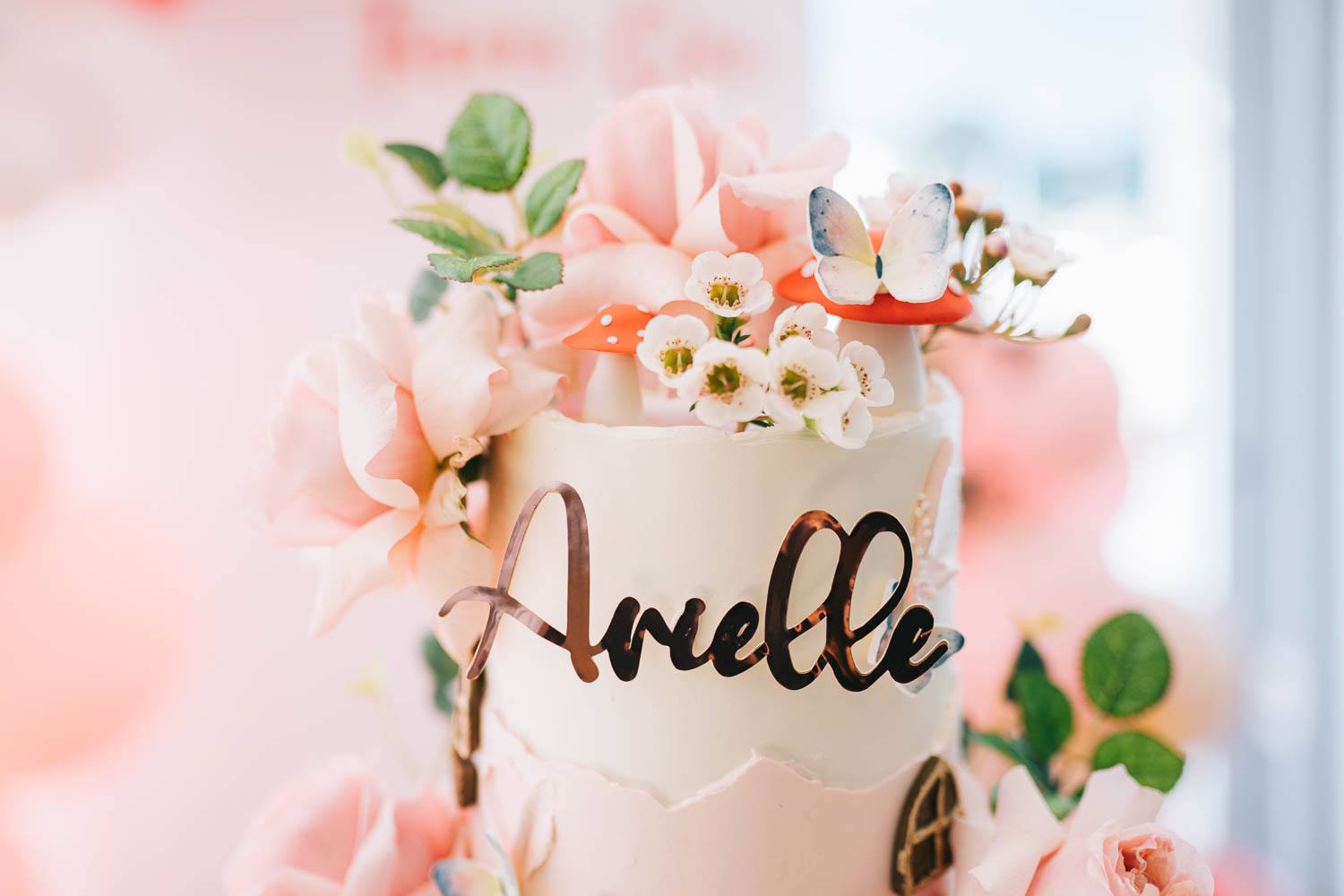 First birthday cake decorated with flowers in pinks and whites