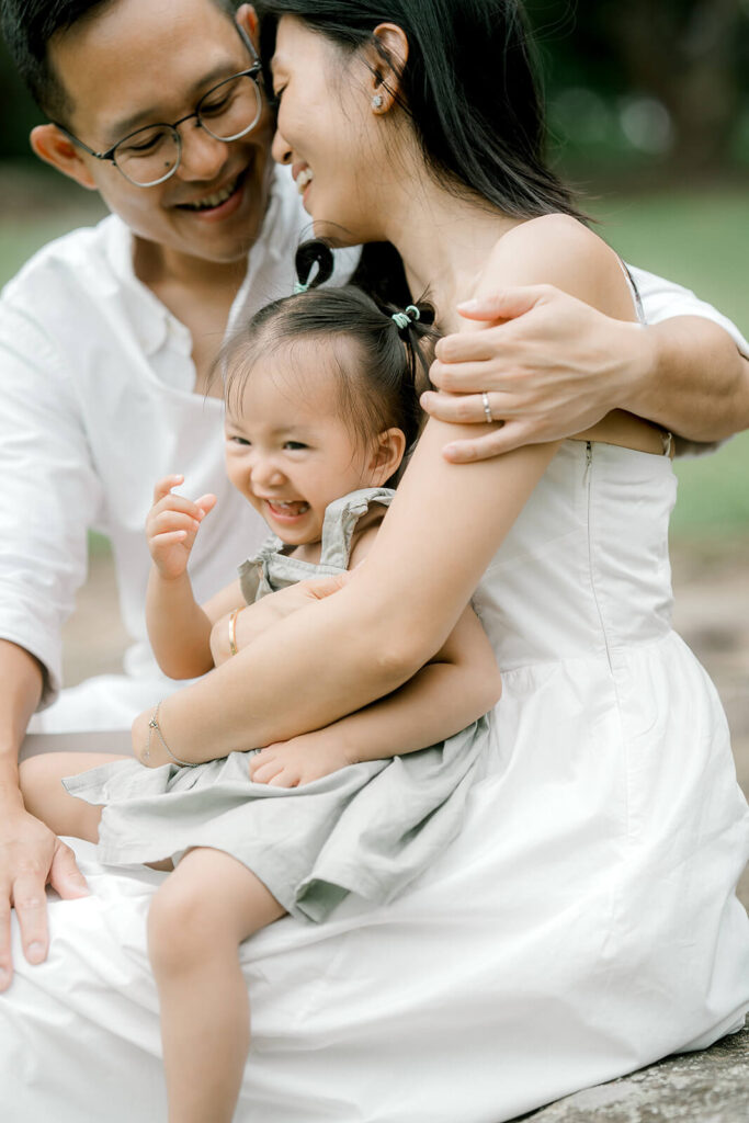 Mother hugging young daughter during an outdoor family photography session,  warm emotional connection