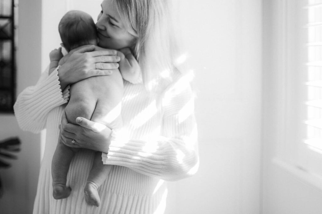 Close-up of parents holding newborn during an in-home photography session in Sydney