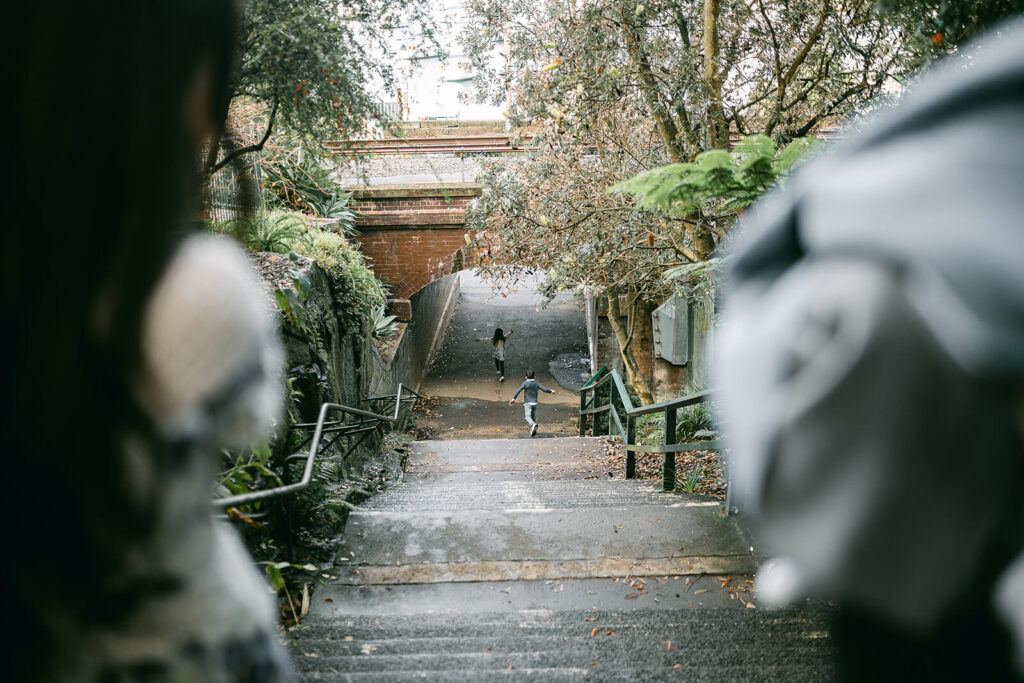 Siblings chasing each other through the lush greenery of Wendy’s Secret Garden