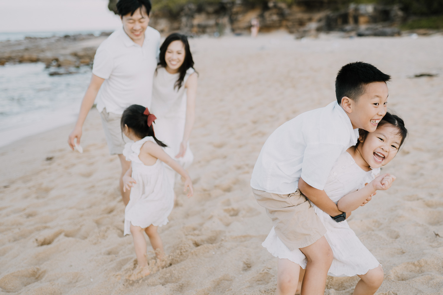 Family of 5 playing by water on a summer afternoon