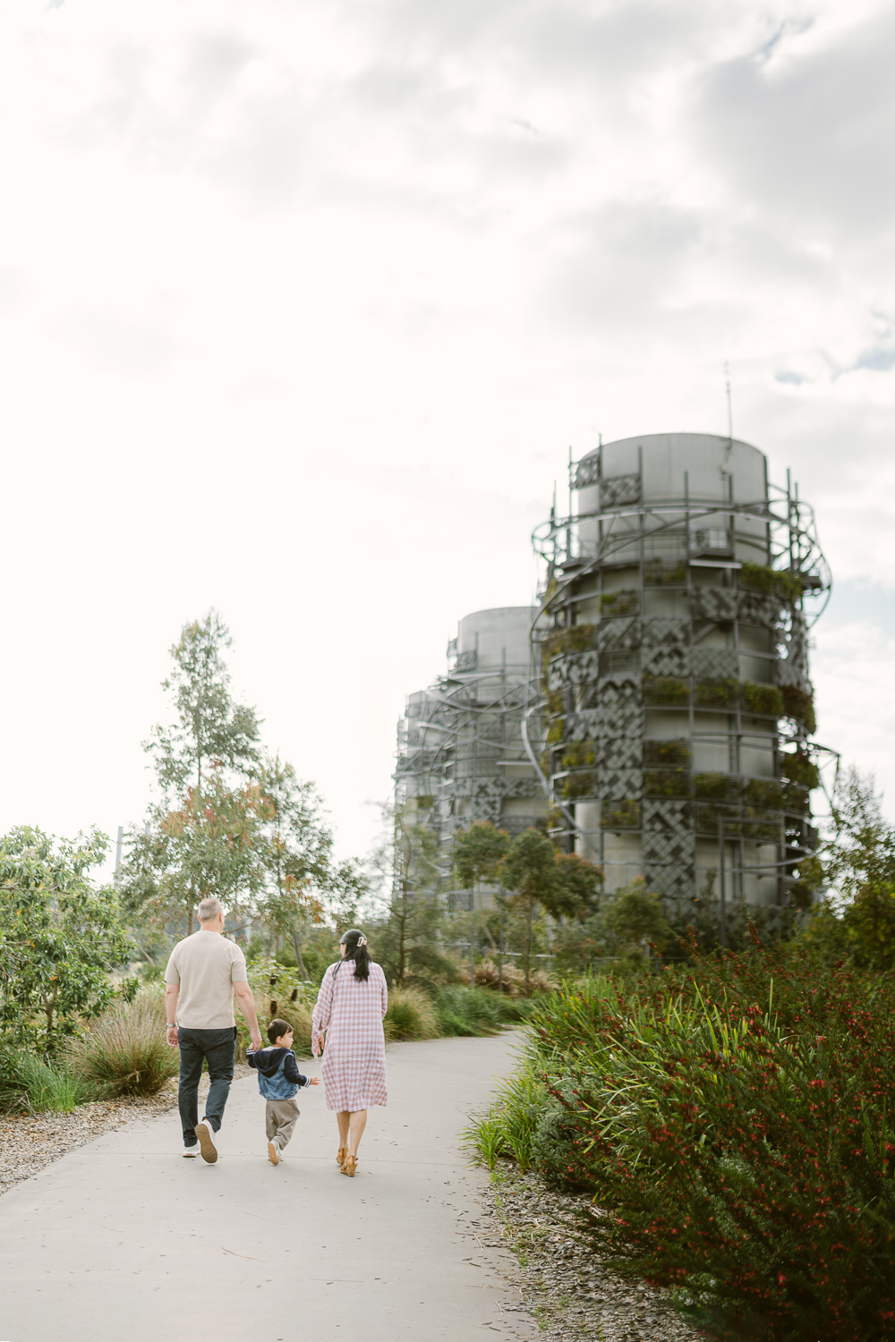 Family of three walking together at Rozelle Parklands in Sydney Inner West